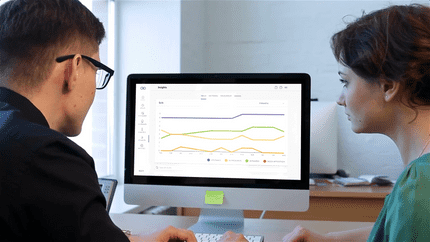 A woman and a man at her computer exploring the Insights page of the Nulia Works website