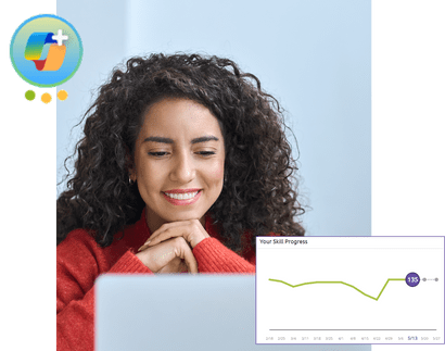 A woman smiling while using her laptop